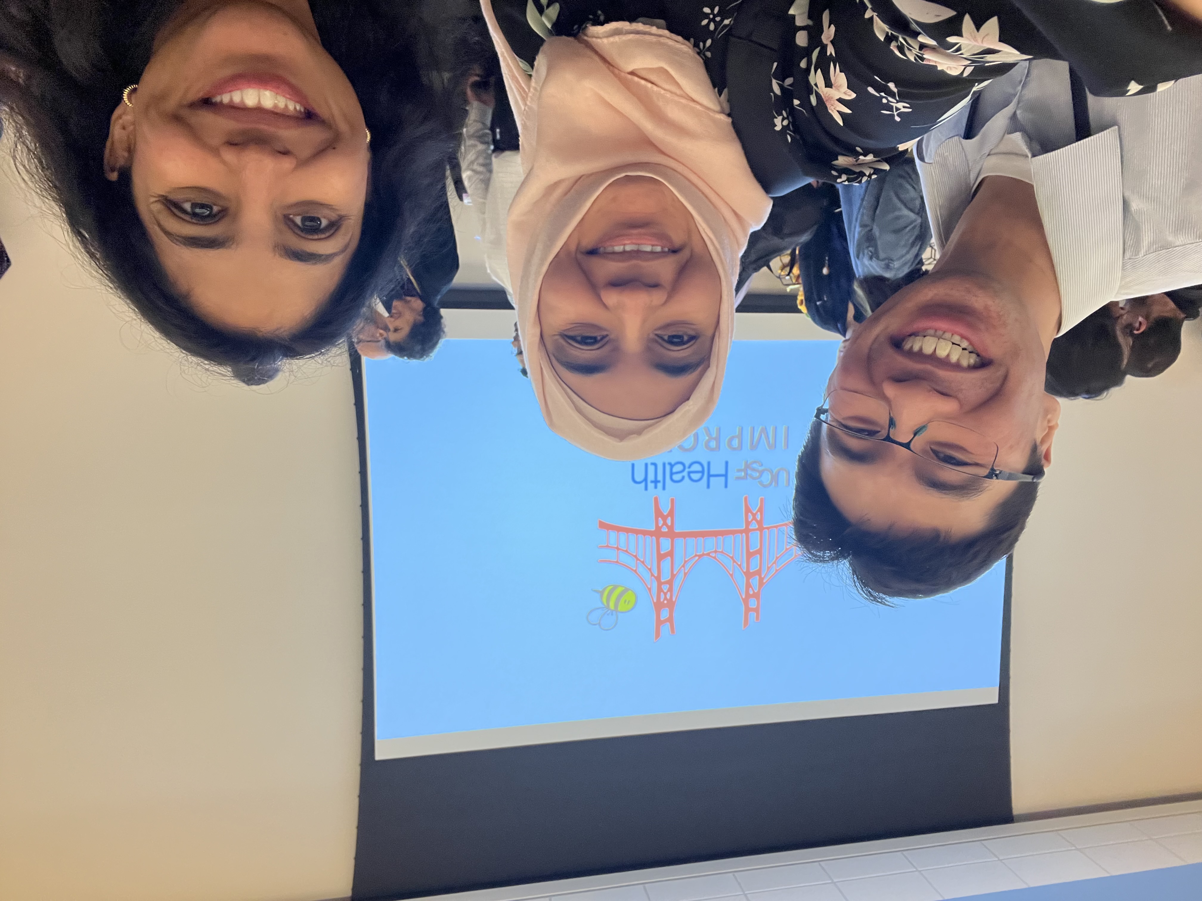 three trainees at the REFLECT symposium 2025